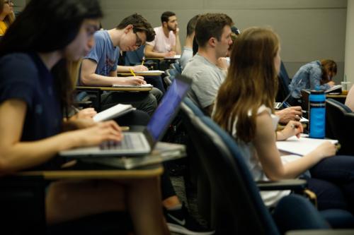 A group of students taking note in a history class